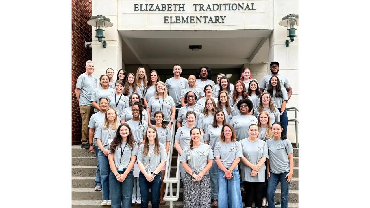 Elizabeth Traditional Elementary staff in matching gray shirts on the school's front steps