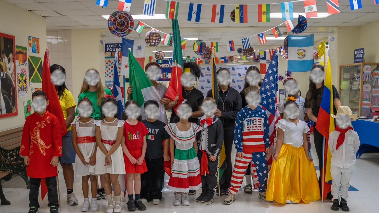 Oaklawn Language Academy students in cultural dress holding flags from many countries at the Multicultural Fair